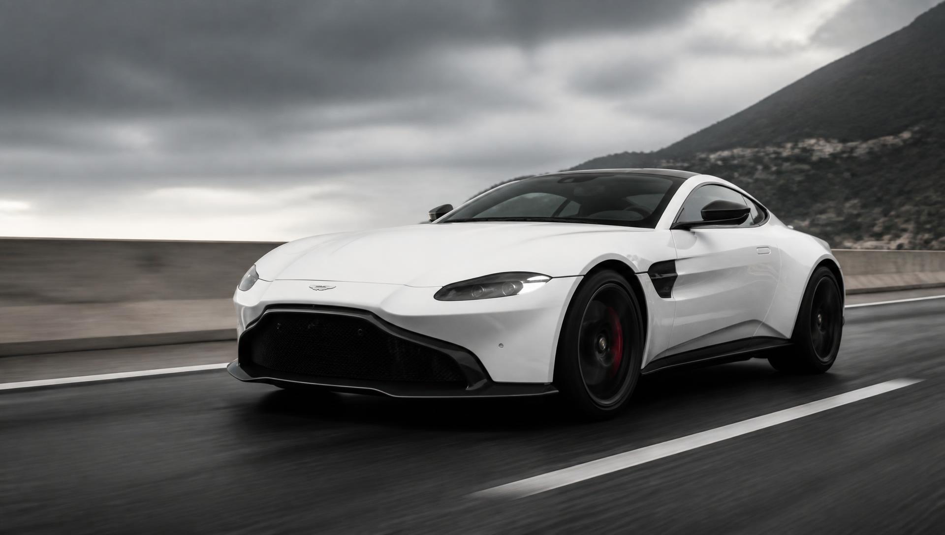 White Aston Martin Vantage driving on a highway
